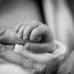 Fibromyalgia - PPD - Infant holding new moms finger