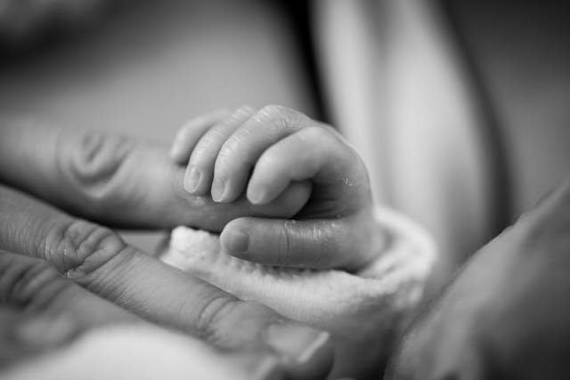 Fibromyalgia - PPD - Infant holding new moms finger